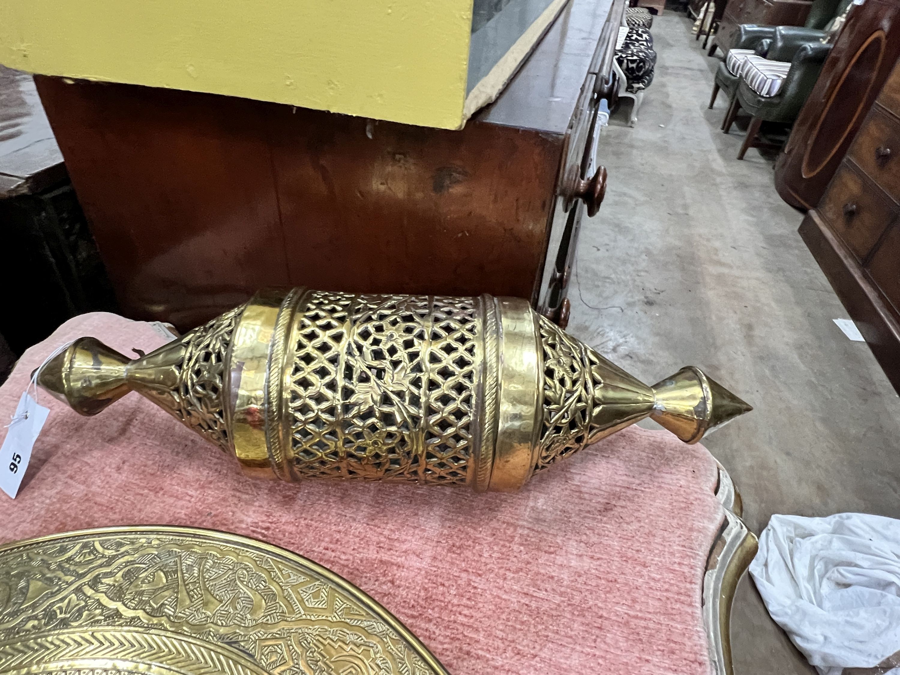 A copper and ruby glass lantern, height 70cm, a Moorish brass lantern, height 52cm and a Benares brass table top